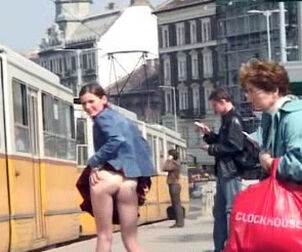 Shameless teenage hoe raises her mini-skirt at the bus stop