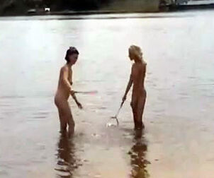 Slim nude nubiles toying badminton on a sea beach.